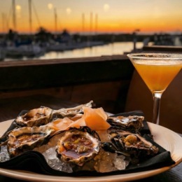 plate of seafood and drink by water