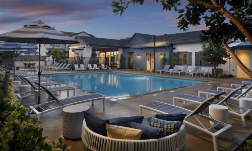 a swimming pool with lounge chairs