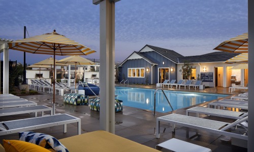 a swimming pool with lounge chairs