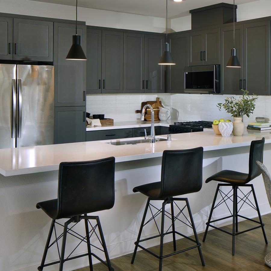 a kitchen with black chairs