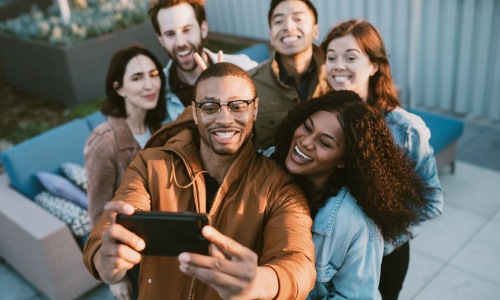 friends take a group selfie outdoors
