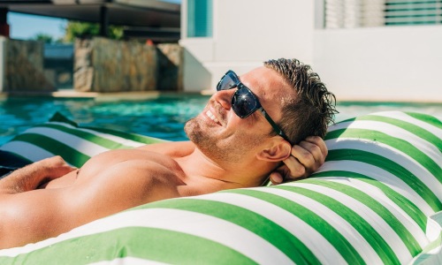 a man on a floaty in a pool